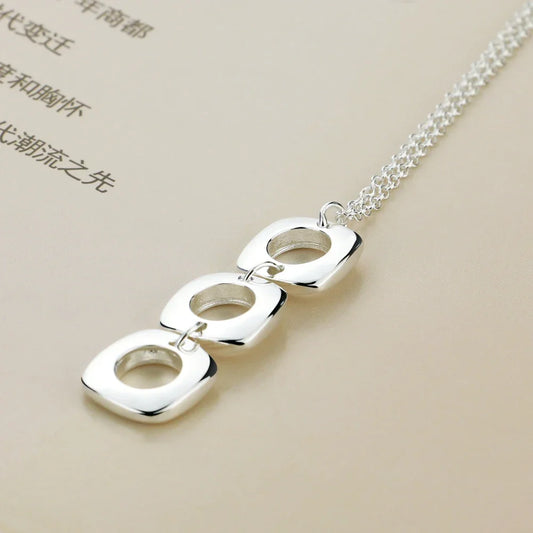 Sterling silver triple charm pendant necklace with three linked hollow square frames
