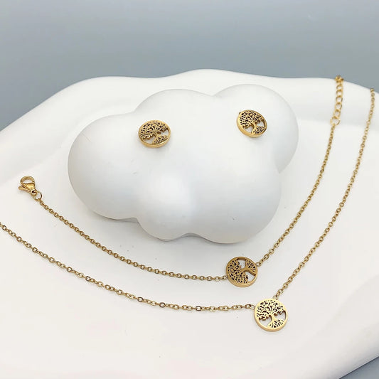 Gold-tone 4-piece tree of life jewelry set with round necklace, bracelet chain, and stud earrings.