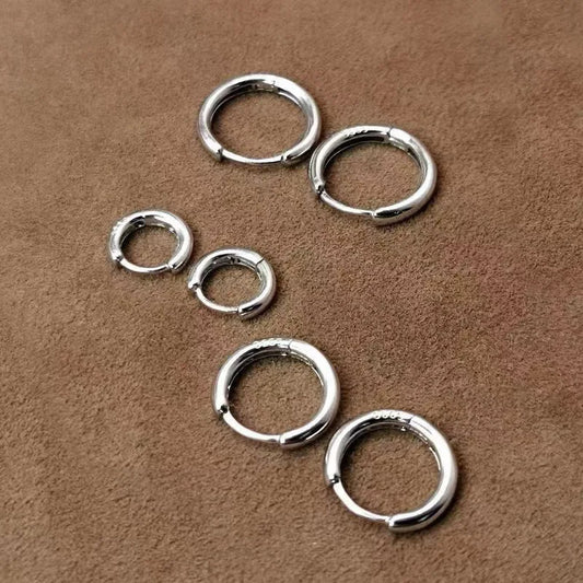 Sterling silver small hoop earrings, smooth circular hoops displayed in a set