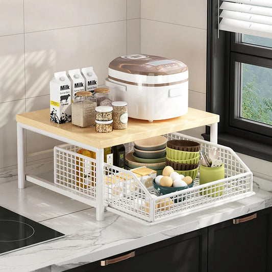 Kitchen countertop organizer with white wire baskets and light wood top shelf