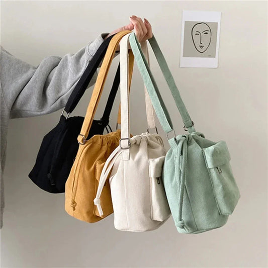 Multi-color drawstring bucket shoulder bags with loop handles and front pocket