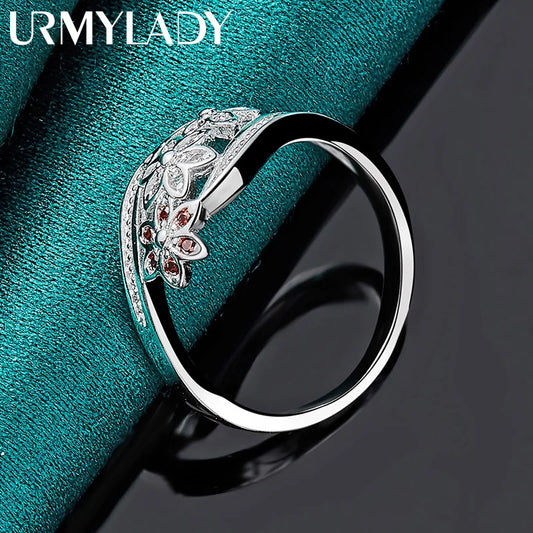 Sterling silver openwork ring with red and clear stones, flower motif