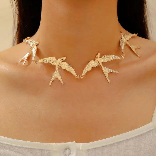 Gold bird charm short necklace with sculpted swallow details, thin chain for women