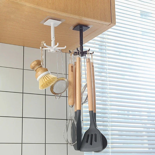 Wall-mounted utensil hook organizer with rotating black base and hanging cookware tools