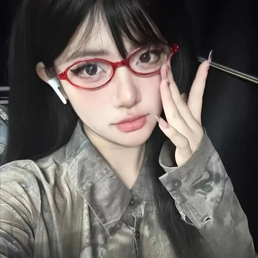 Small oval eyeglasses with red frame and clear lenses