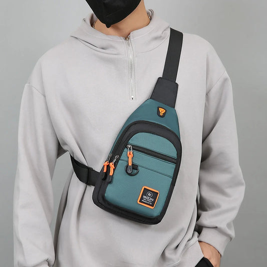 Men's teal chest bag with black shoulder strap, front zipper pocket and orange pulls