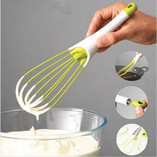 Yellow-green manual egg beater whisk with white handle and silicone wire loops