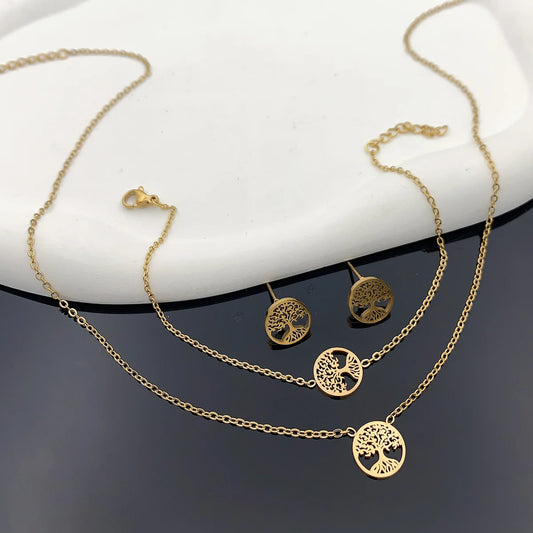 Gold-tone 4-piece tree of life jewelry set: round pendant necklace, bracelet, stud earrings.
