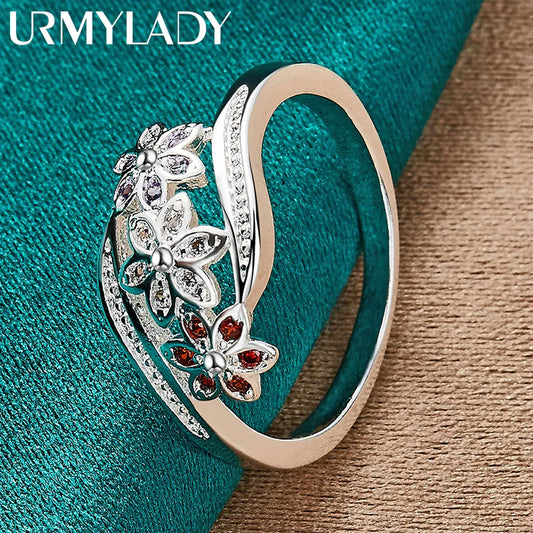 Sterling silver ring with red zircon flower cluster and butterfly-style side accents