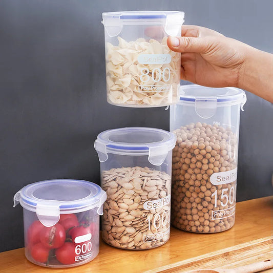 Transparent sealed plastic food storage jars with snap lids, filled with assorted dry foods