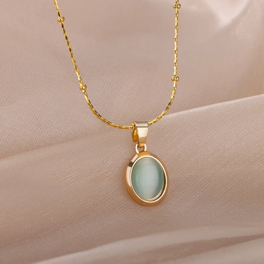 Gold-plated oval opal pendant necklace with light green teardrop stone pendant