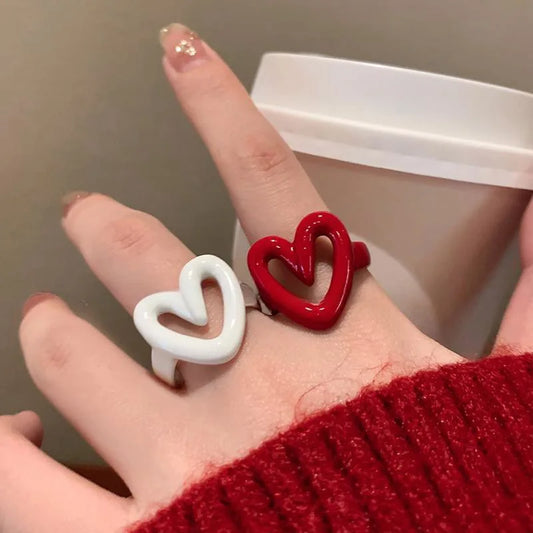 Open heart enamel rings, white and red, worn on fingers
