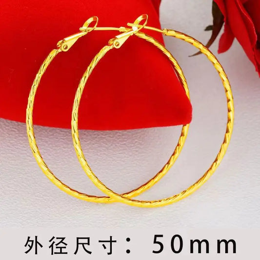 Large round gold hoop earrings with clasp, smooth polished finish