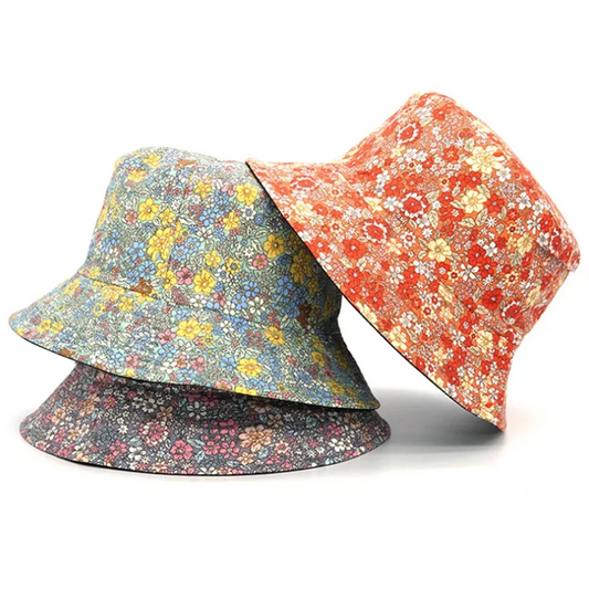 Reversible floral bucket hat, orange side with small white flowers and dark patterned brim
