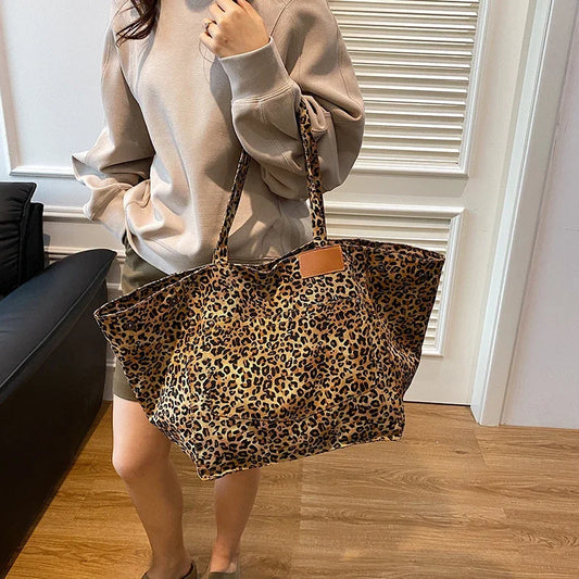 Leopard print canvas tote handbag with brown leather patch and long shoulder straps