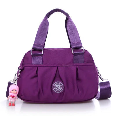 Purple nylon oxford shoulder crossbody bag with top handles and side zipper pockets