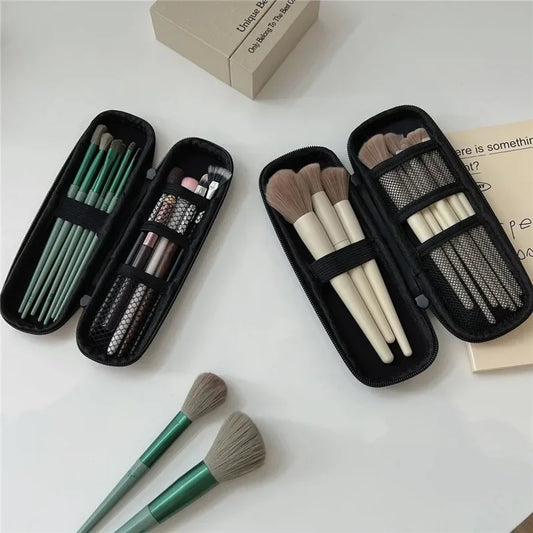 Black zippered makeup brush case with mesh pockets and elastic brush holders, open