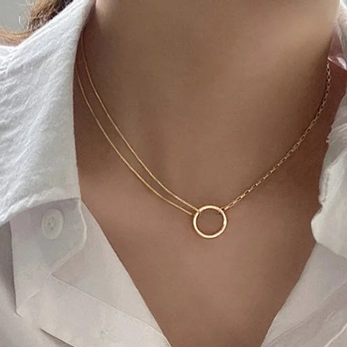 Gold round ring pendant necklace on model, thin layered chain