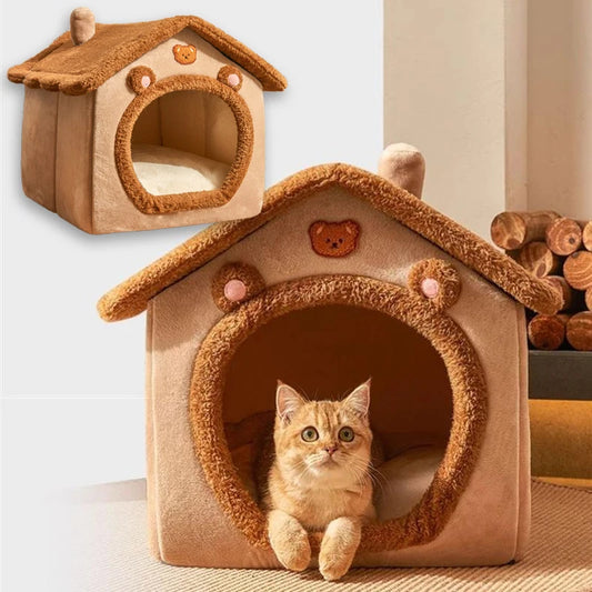 Brown foldable pet house with round tunnel entrance and small cat resting inside