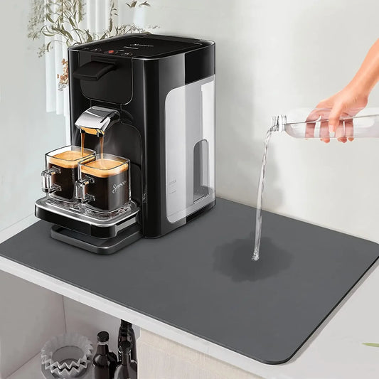 Large black kitchen drying mat with rounded corners on tabletop