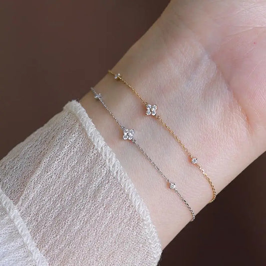 Gold and silver zirconia flower chain bracelet set with small clasp on wrist
