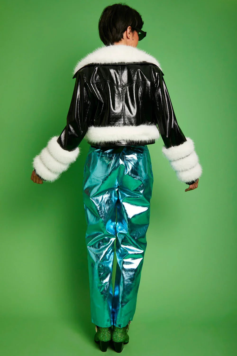 Black faux leather biker jacket with white faux fur back trim and cuffs, rear view