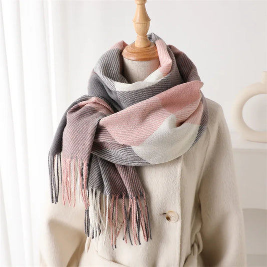 Plaid blanket scarf with pink, gray, and white stripes and long fringe ends