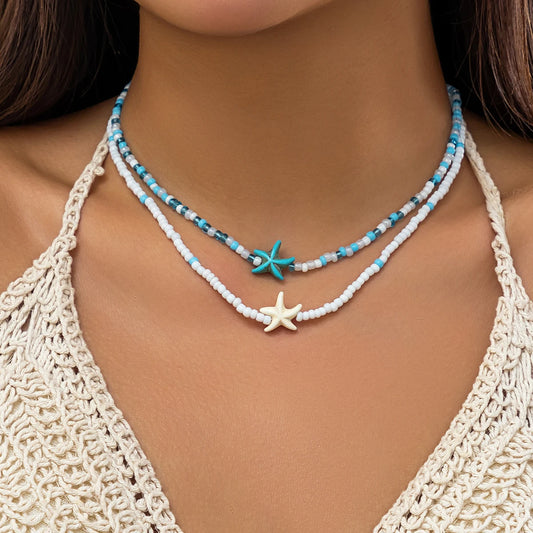 Layered seed bead choker necklace with white/blue beads and starfish & turtle charms