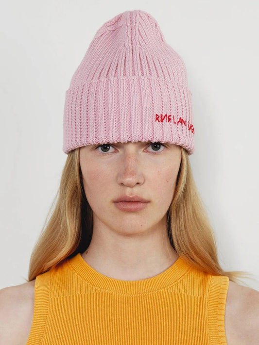 Pink rib-knit beanie with folded cuff and embroidered red logo on front