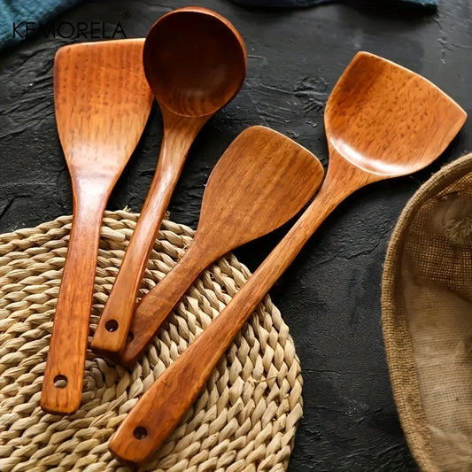 KEMORELA wooden cooking utensil set with four spatulas and scoops on a woven mat