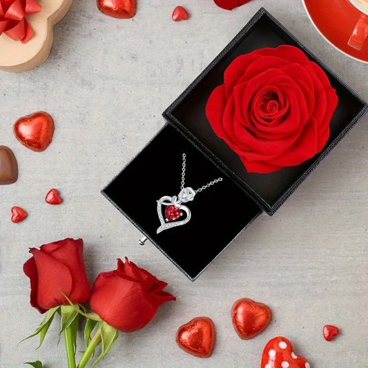 Silver heart pendant necklace with red gemstone, inside black gift box with red rose