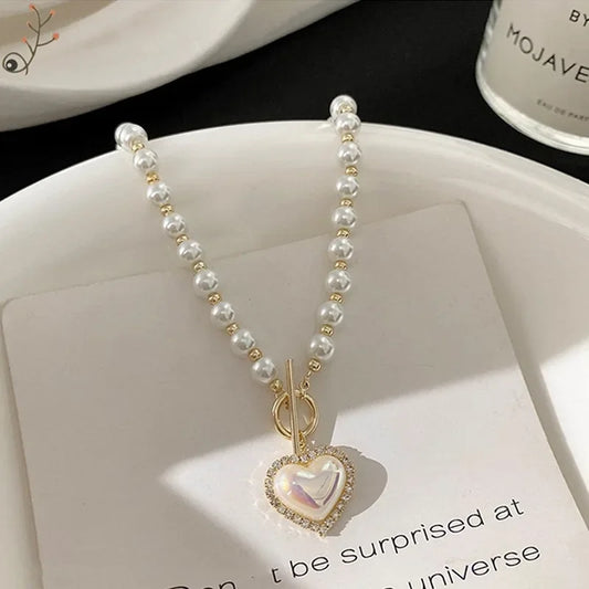 Faux pearl collar necklace with heart pendant charm on double-bead strand, gold accents