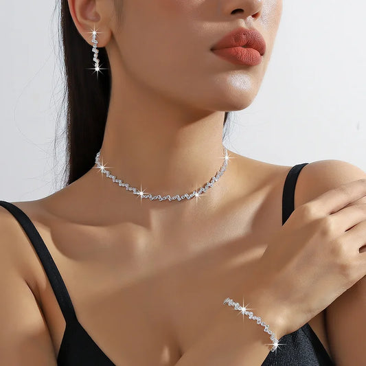 Silvery rhinestone necklace with matching drop earrings and bracelet on model