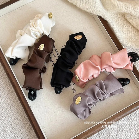 Satin banana hair clip set with black, gray, brown, and white ruffled pieces