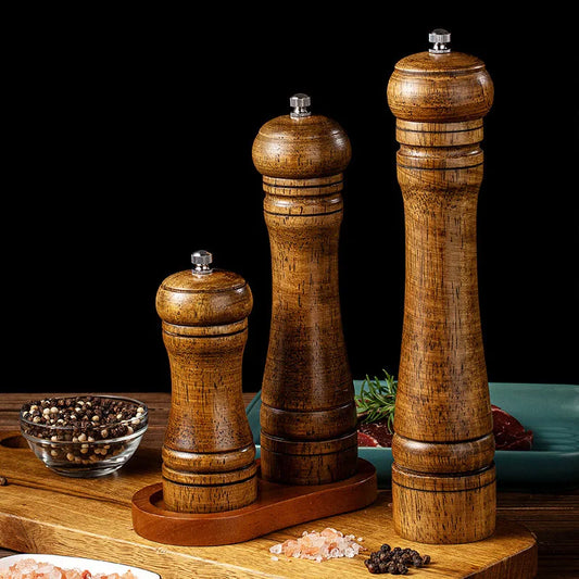 Set of wooden salt and pepper grinders with metal tops on a small base stand