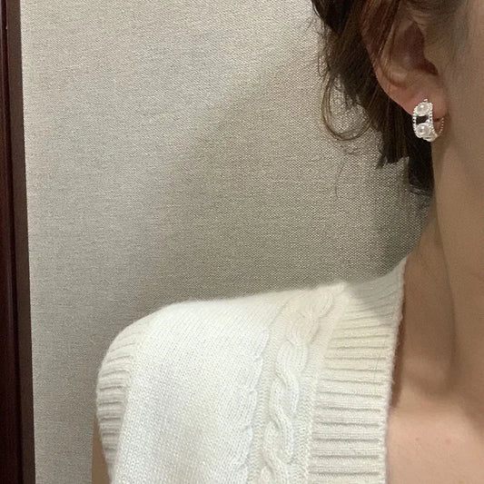 Silver hoop earrings with pearl bead detailing on the outer hoop
