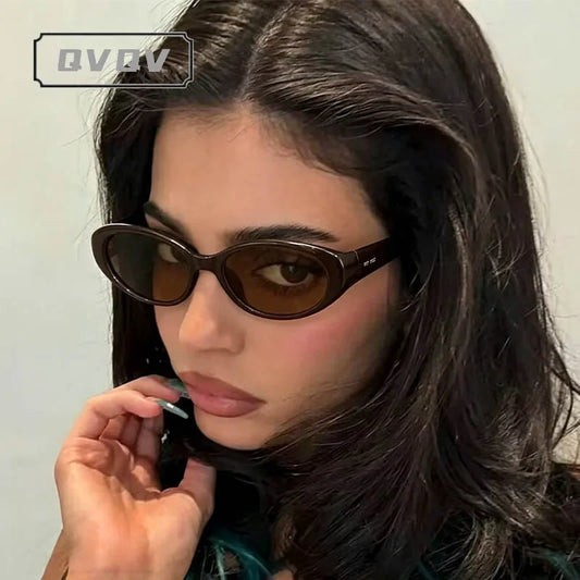 Small oval sunglasses with dark frame and brown tinted lenses, worn
