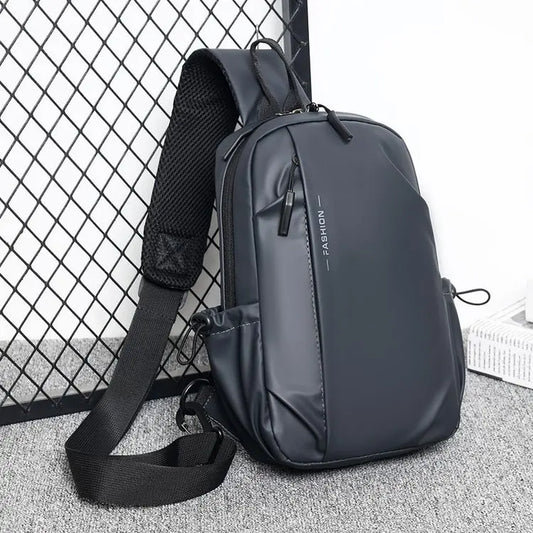Waterproof chest crossbody bag in dark gray with wide adjustable strap and top handle.