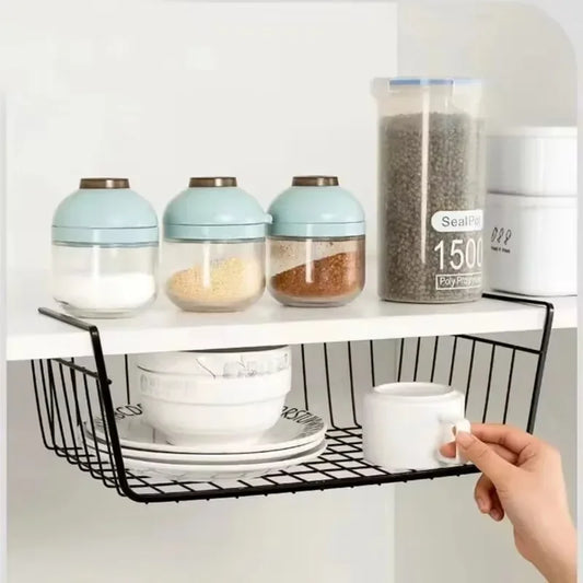 Black wire wall shelf with front basket, holding kitchen jars and plates