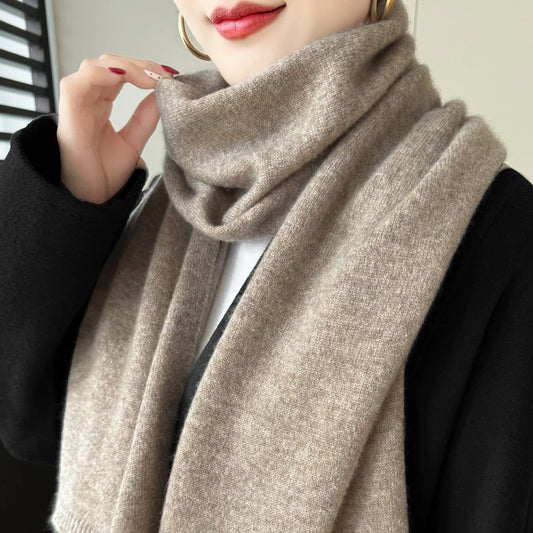 Beige cashmere knit scarf worn around the neck, soft drape with no visible fringe.