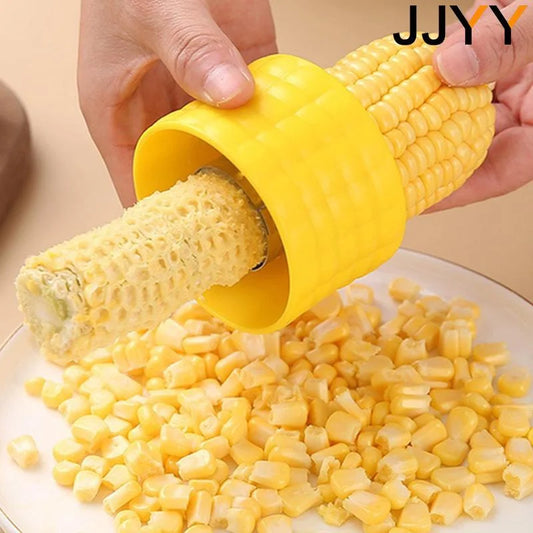 Yellow corn cob peeler tool removing kernels from a corn cob section