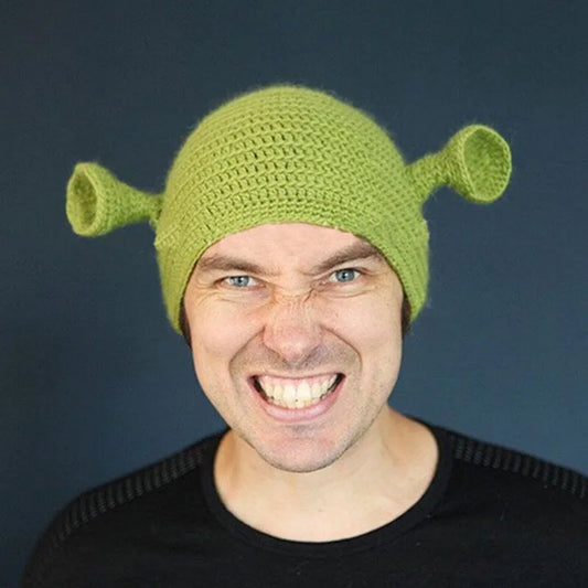Green knitted monster hat worn on head with small ear nubs