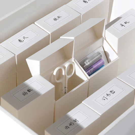 White plastic photocard storage organizer with flip-lid drawers and small interior compartments