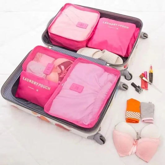 Pink 6-piece travel organizer with mesh pouches inside a rolling suitcase organizer set