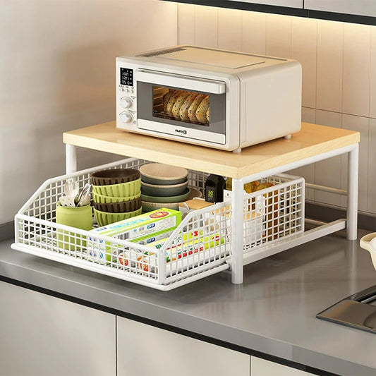 Kitchen countertop organizer with white wire storage baskets under a light wood shelf