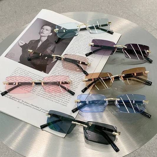 Assorted rimless sunglasses with colorful frames and tinted lenses, gold-tone accents