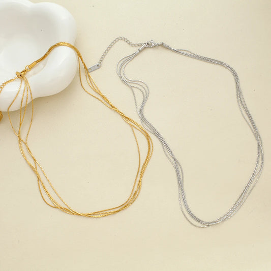 Layered thin snake chain necklaces, gold and silver tones with small clasp