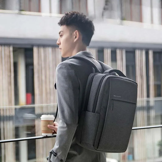 Dark gray laptop backpack worn on back with front organizer pocket.