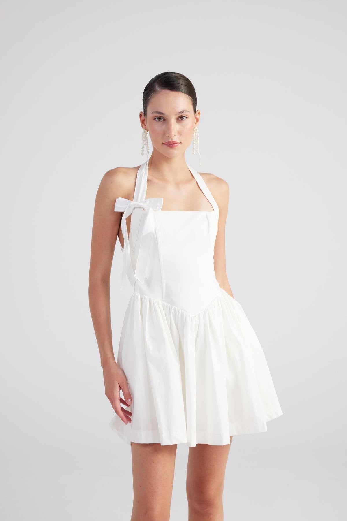 White pleated mini dress front view, square neckline with ribbon bow detail