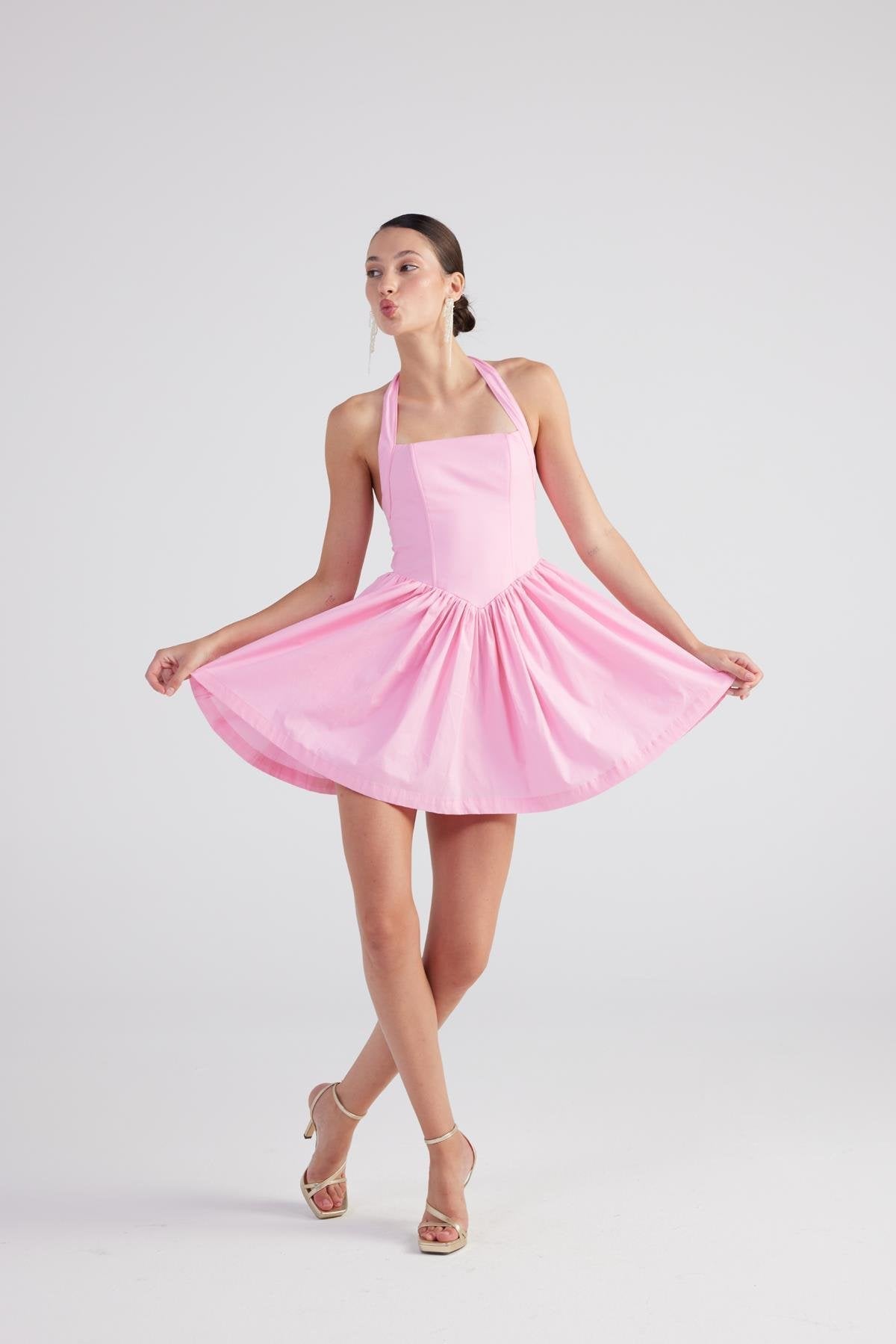 Pink halter mini dress with flared pleated skirt, sleeveless halter fit